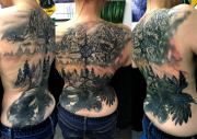 Large Black and Gray Tattoo Back Piece of mountains and Ravens used as a cover up on lower back of tribal. These are African Ravens and a Magpie. Done at Art In Motion Tattoos In Colorado Springs.