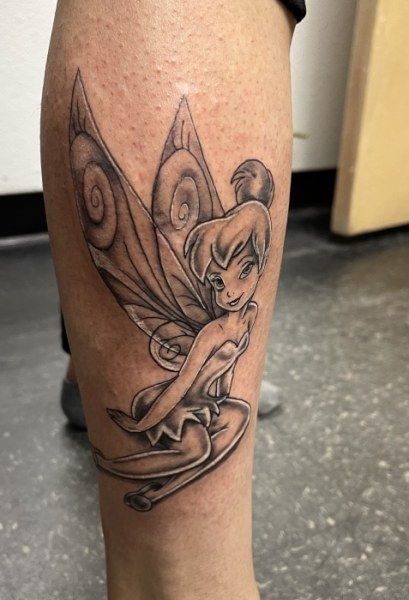 Tinker bell tattoo on leg.