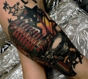 Red velvet microphone tattoo with speakers and stars on leg.