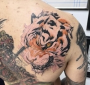 Tiger Head Tattoo done on shoulder, colored white and orange.