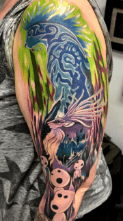 Ghibli tattoo of the Forest spirits transformation as a sleeve tattoo, Bright Green back ground with Purple and blue for colors in the Guardians, done In Colorado Springs at Art in Motion Tattoos Studio.