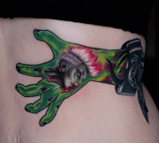 Zombie hand with tank girl tattooed on it, on rib cage, art in motion tattoos, colorado springs.