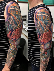 Doctor who tattoo with Tardis on top of the sleeve  with bright colors and designs throughout arm. At Colorado Springs Tattoo Studio.