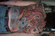 Full backpiece dragon tattoo with Japanese style scales and flames, done by Mark at Art In Motion Tattoos in Colorado Springs.