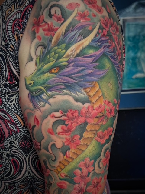 Colorful Dragon Tattoo by Shelly at Art In Motion Tattoos.