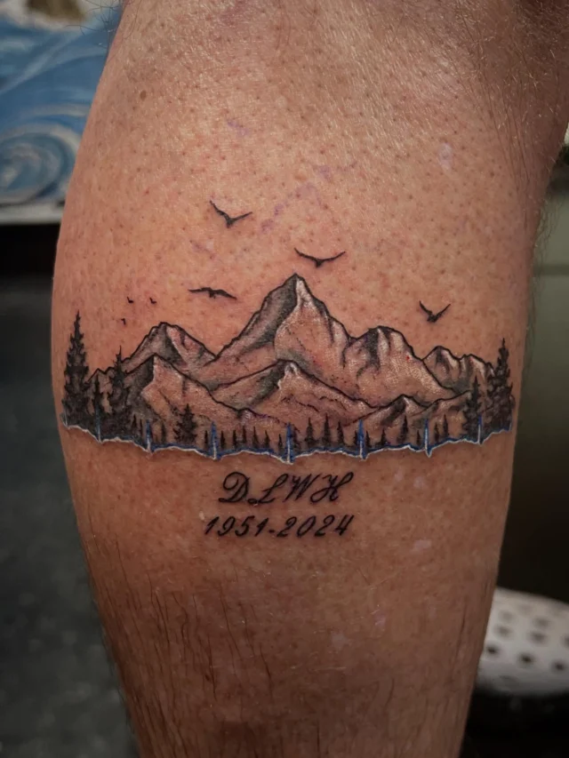 Mountains and heart beat on leg by Mark at Art In Motion Tattoos.  #artinmotiontattoosandpiercing #coloradosprings #coloradospringstattooartist #mountaintattoo #heartbeat #heartbeattattoo #blackamdgreytattoo #landscapetattoo